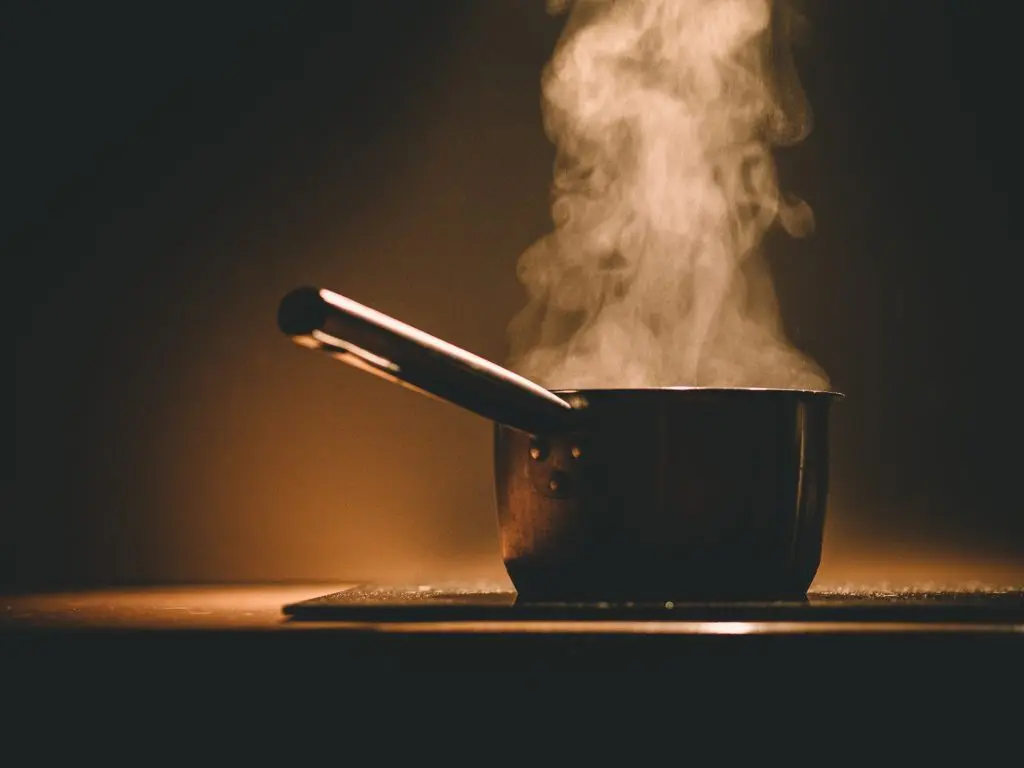 Image of pan on a hob with steam coming from it.