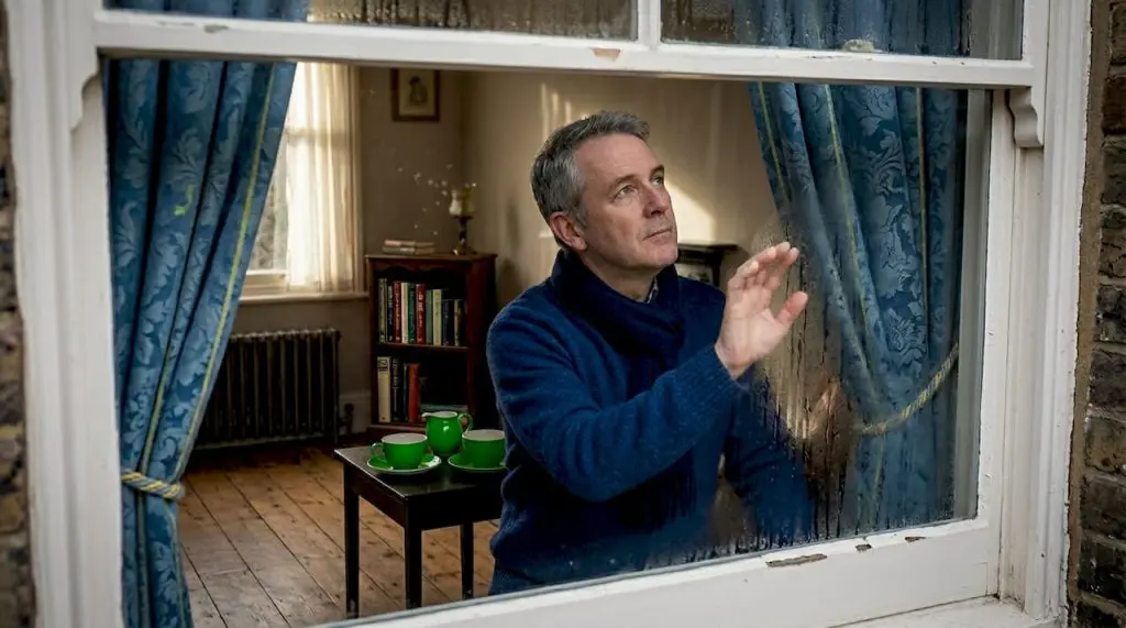 Homeowner inspecting heritage window interior