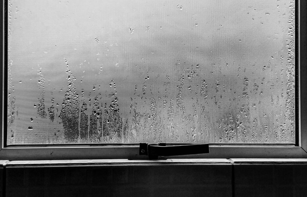 A cracked window seal letting in cold air, a common cause of draughts.