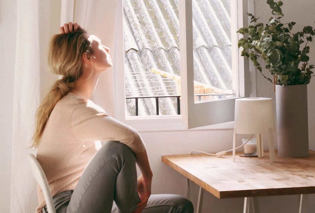 C2C Woman gazing out of clear window