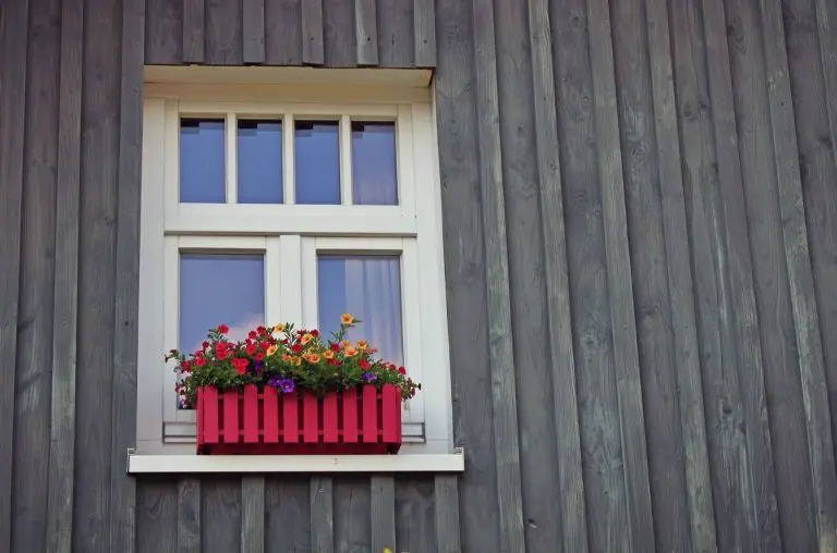 Image of a window with a flowerbox on the window ledge. 