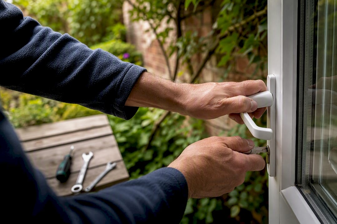 Hands testing uPVC door handle and key after fix
