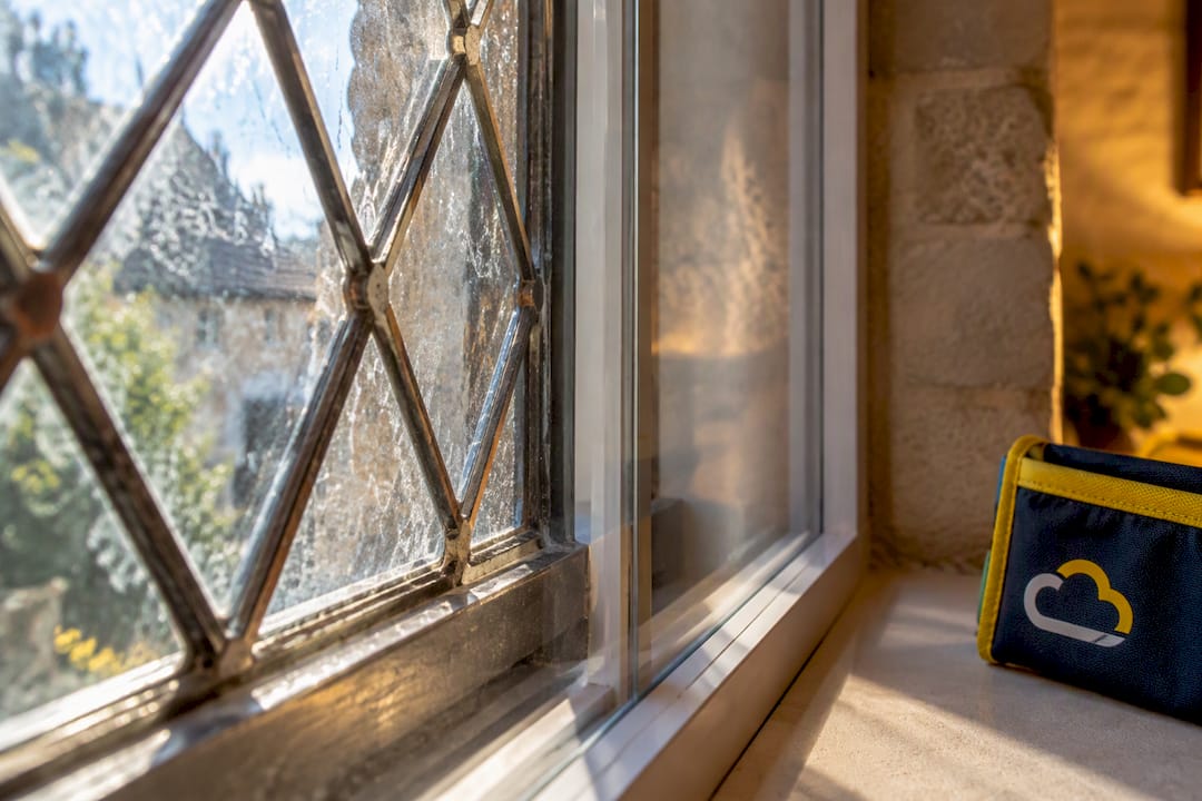 Original leaded glass beside secondary glazing