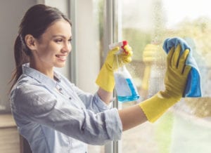 Woman cleaning her house windows