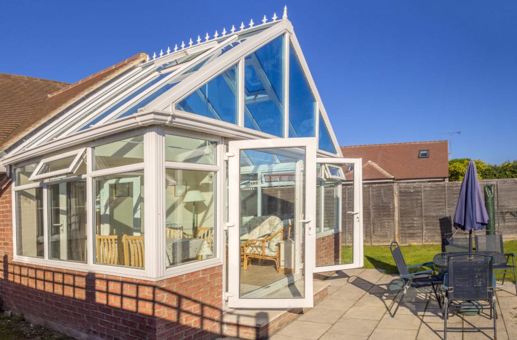 Picture of a conservatory with patio, doors open