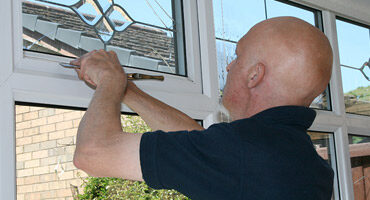 Window fitter installing double glazing
